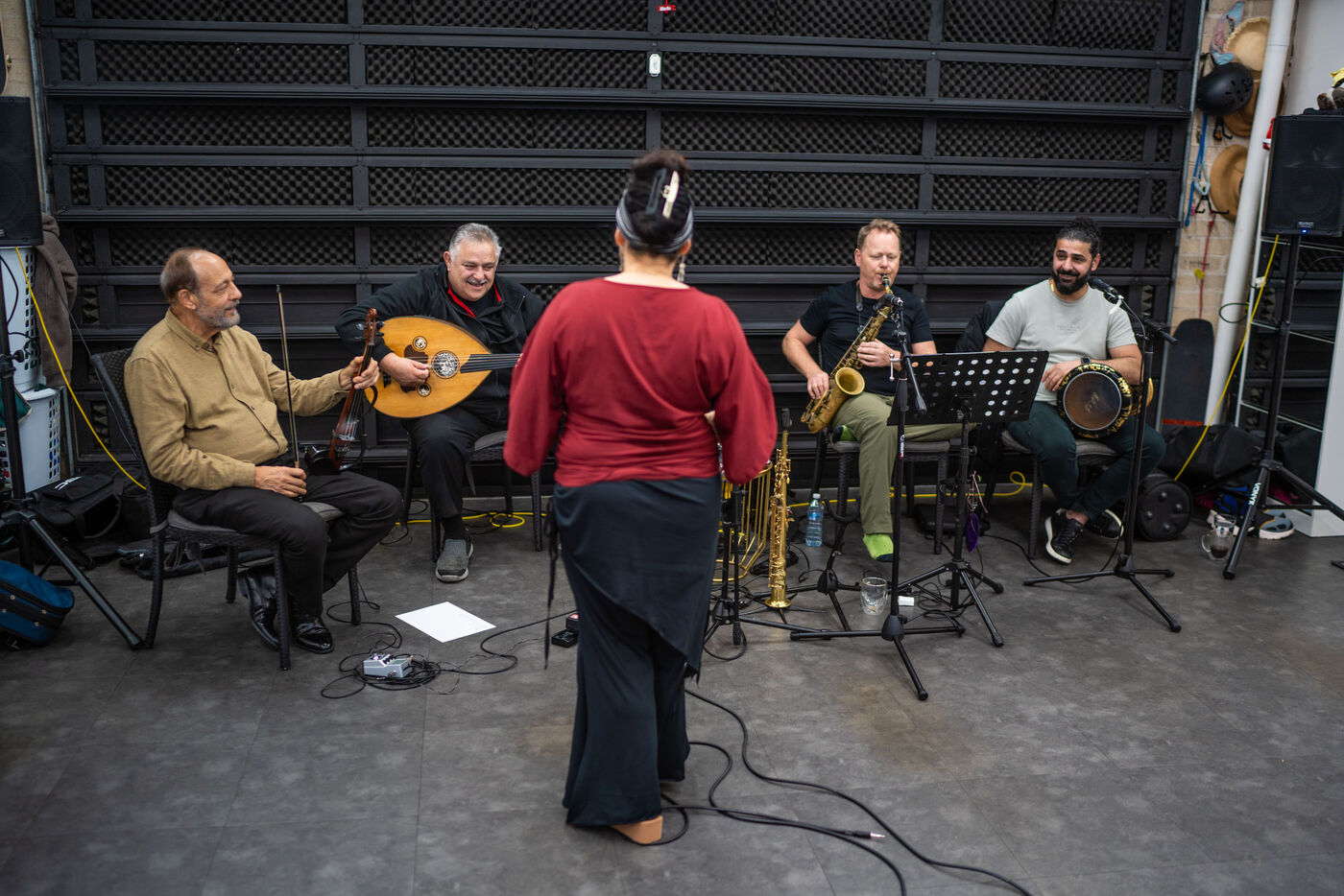 Jrisi facing the live band during a rehearsal