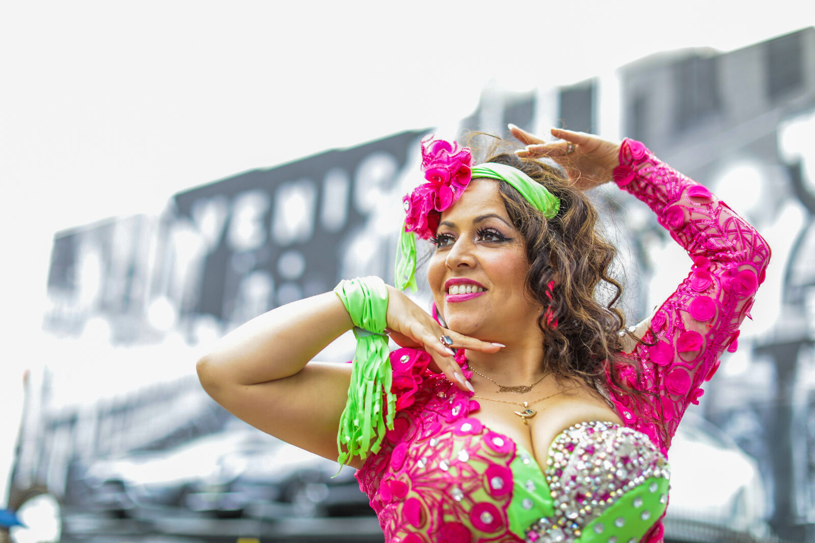 Jrisi performing in a pink and green costume