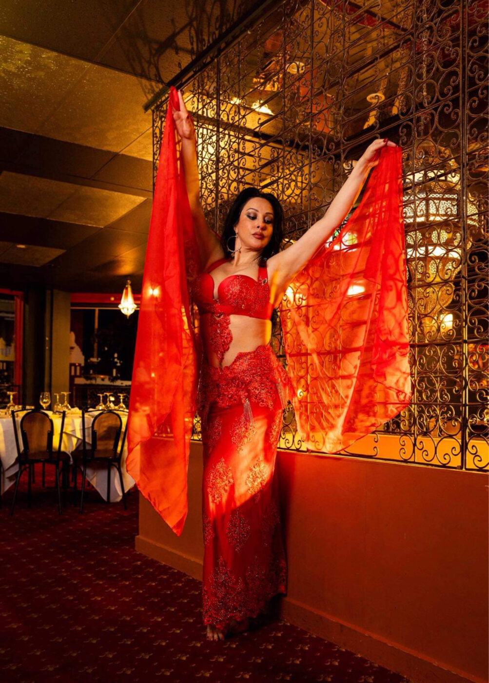 Virginia Masri in a red costume
